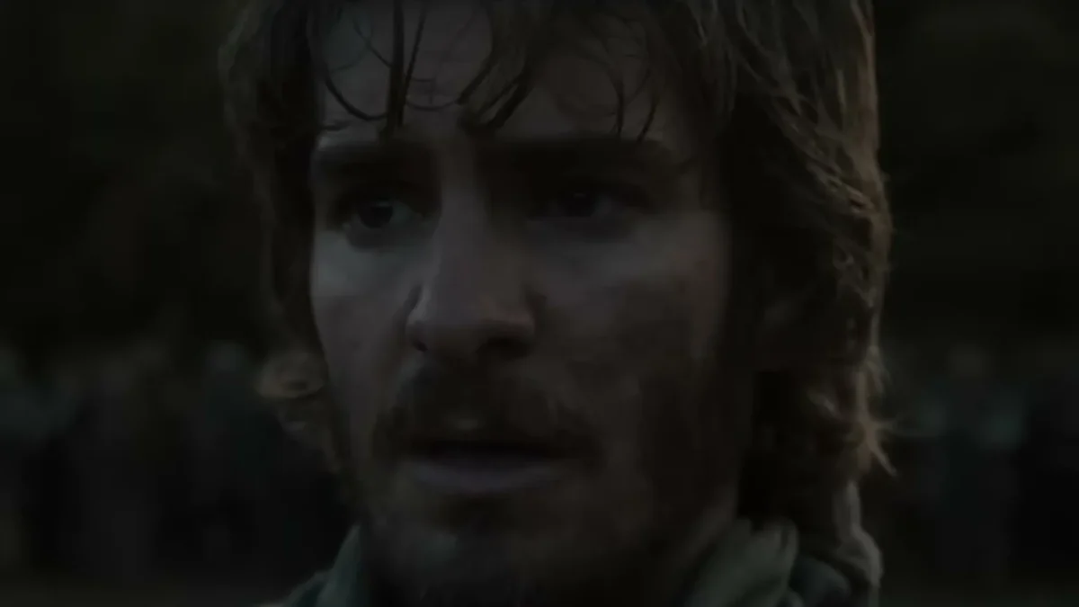 Andrew Garfield with wet, shaggy hair and a beard, in medieval peasant clothes, in a scene from The Uprising