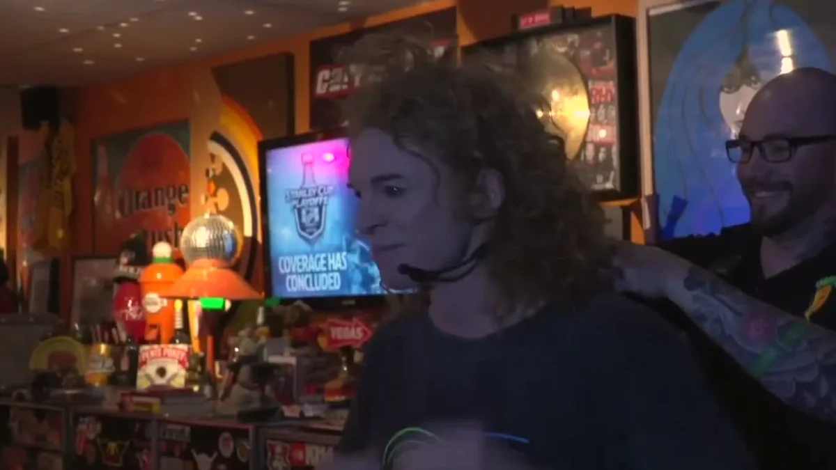 Carrot Top being fitted with a microphone by a crew member before a show at the Luxor