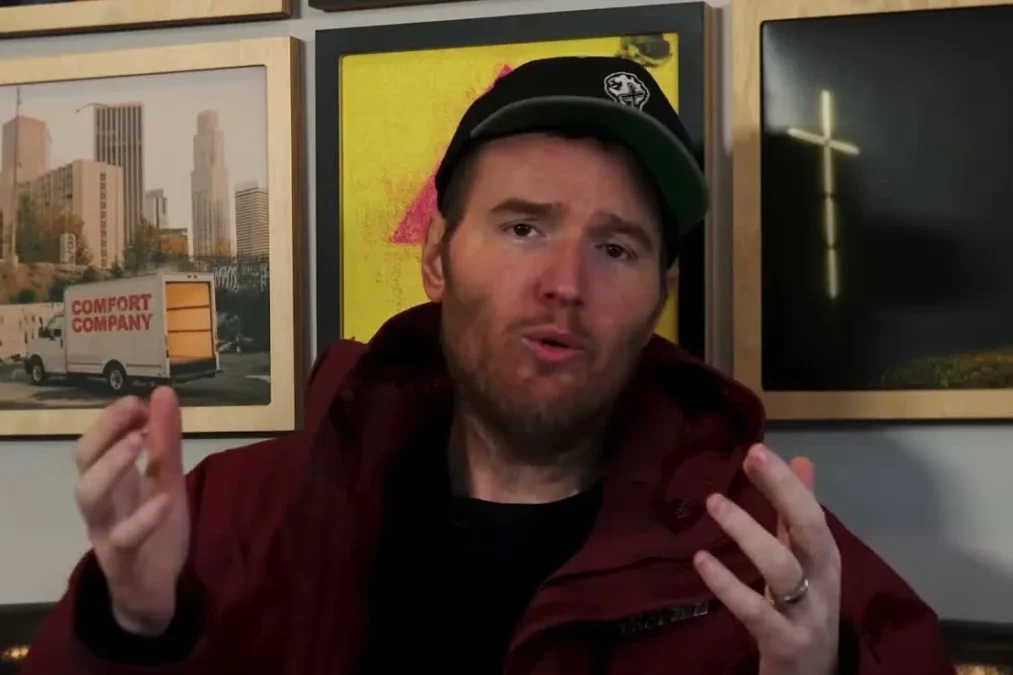 Chad Gilbert gesturing with both hands while talking about New Found Glory's album Listen Up!