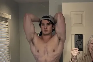 Braden Peters flexing shirtless in a mirror selfie, the kind of physique content that built his looksmaxxing following