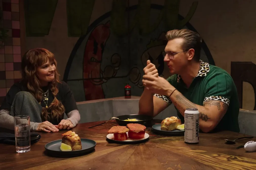 Debby Ryan seated across the table from host Josh Scherer on Last Meals