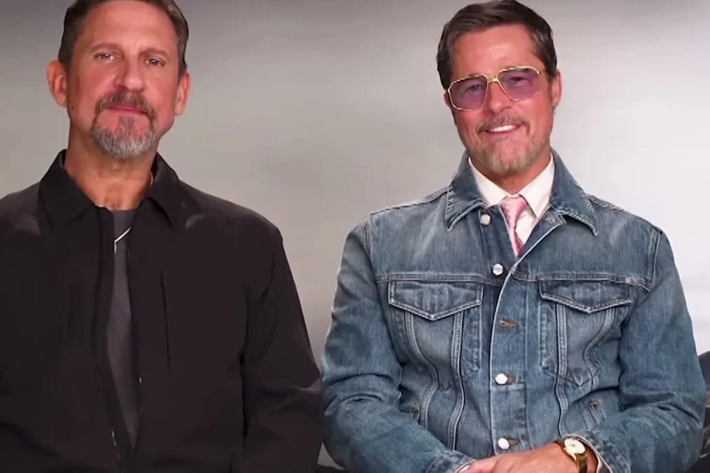 Director David Ayer in a black shirt and Brad Pitt in a denim jacket and tinted glasses during a radio interview