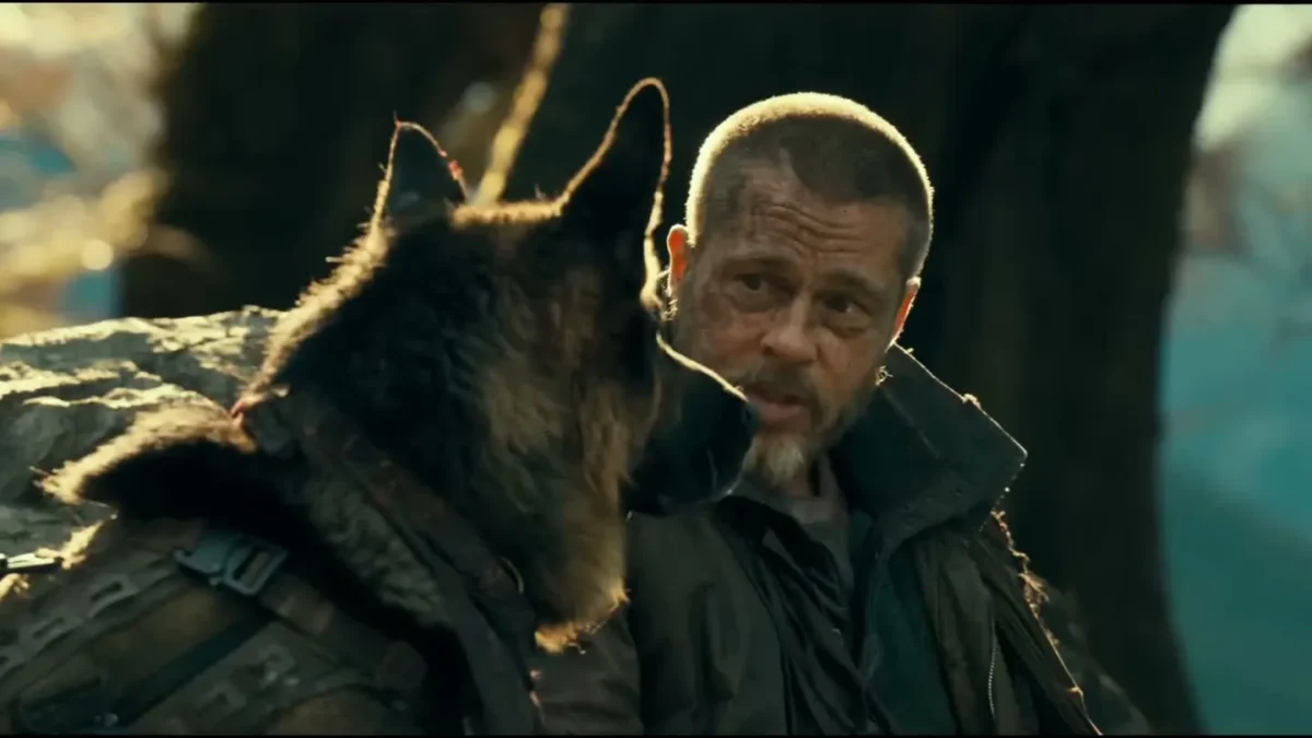 Brad Pitt as James Belmont sitting beside a German shepherd in the forest in Heart of the Beast