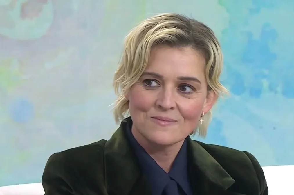 Brandi Carlile in a dark green velvet blazer smiling on the TODAY show set