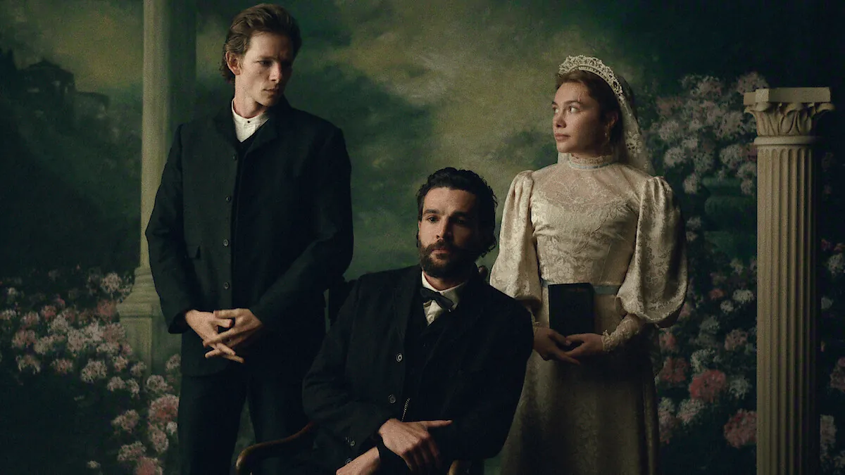 Mike Faist standing, Christopher Abbott seated and Florence Pugh in a wedding dress posing for a formal portrait in East of Eden