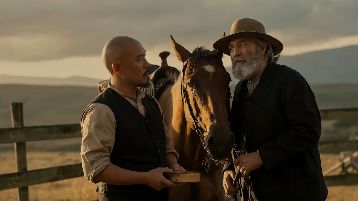 Hoon Lee and Ciarán Hinds standing beside a horse at a fence in the Salinas Valley in East of Eden