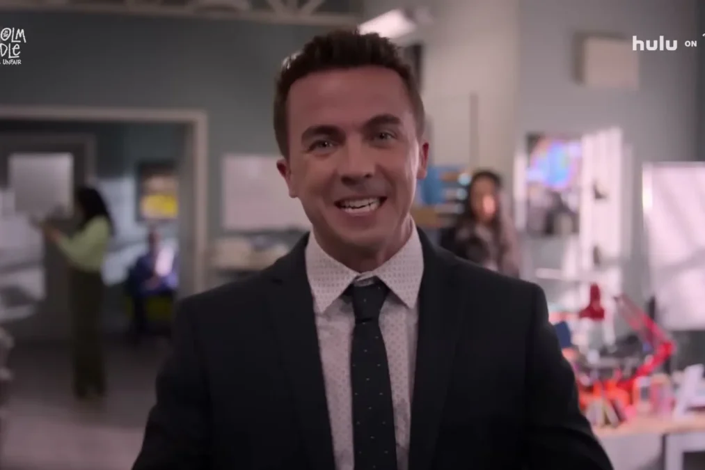Frankie Muniz as an adult Malcolm in a suit and tie in Malcolm in the Middle: Life's Still Unfair