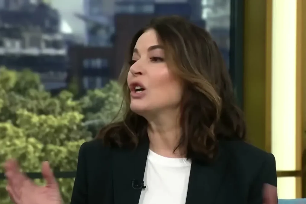 Nigella Lawson in a black blazer talking on the This Morning sofa