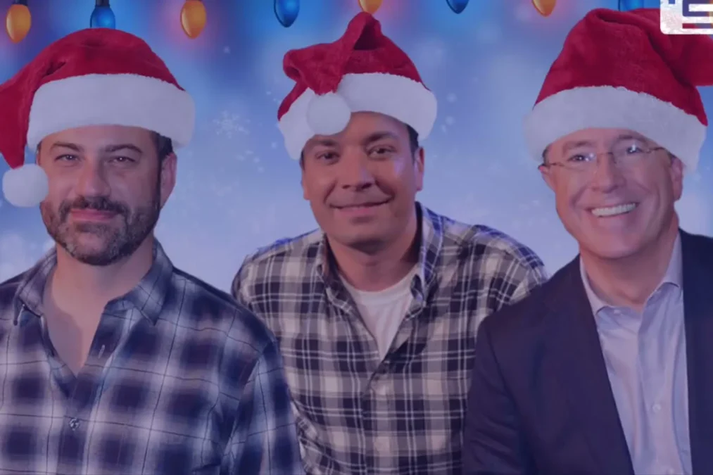 Jimmy Kimmel, Jimmy Fallon and Stephen Colbert wearing Santa hats in a holiday promo image