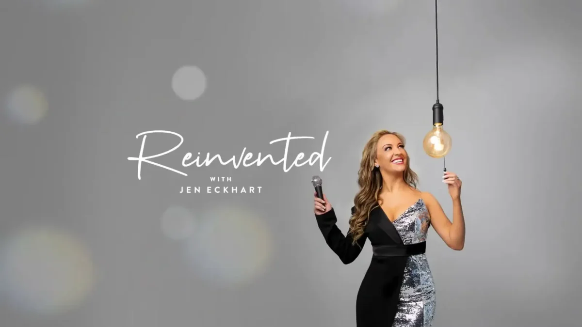 Promotional art for the podcast Reinvented With Jen Eckhart, with Eckhart holding a microphone under a hanging bulb