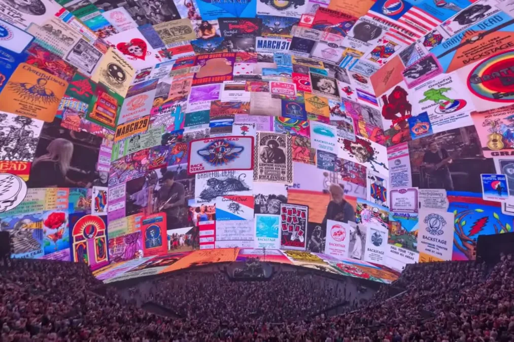 The inside of Sphere in Las Vegas, its dome screen covered in Grateful Dead concert posters above a packed crowd