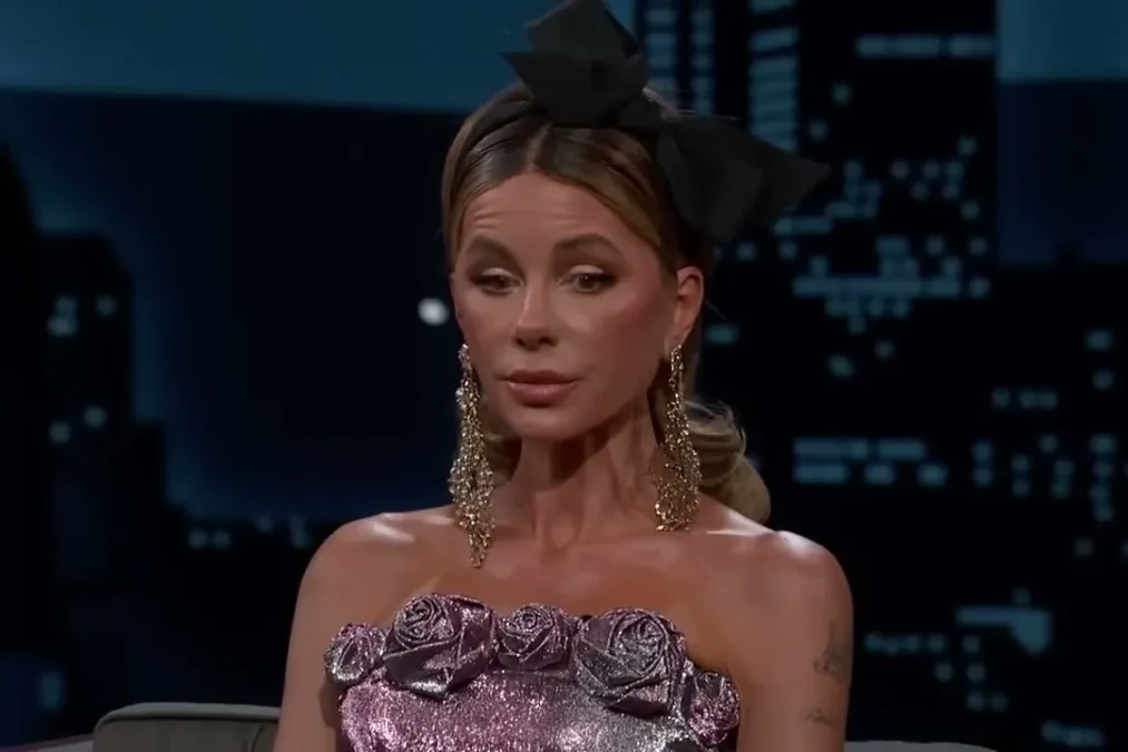 Kate Beckinsale with a black hair bow and drop earrings on Jimmy Kimmel Live