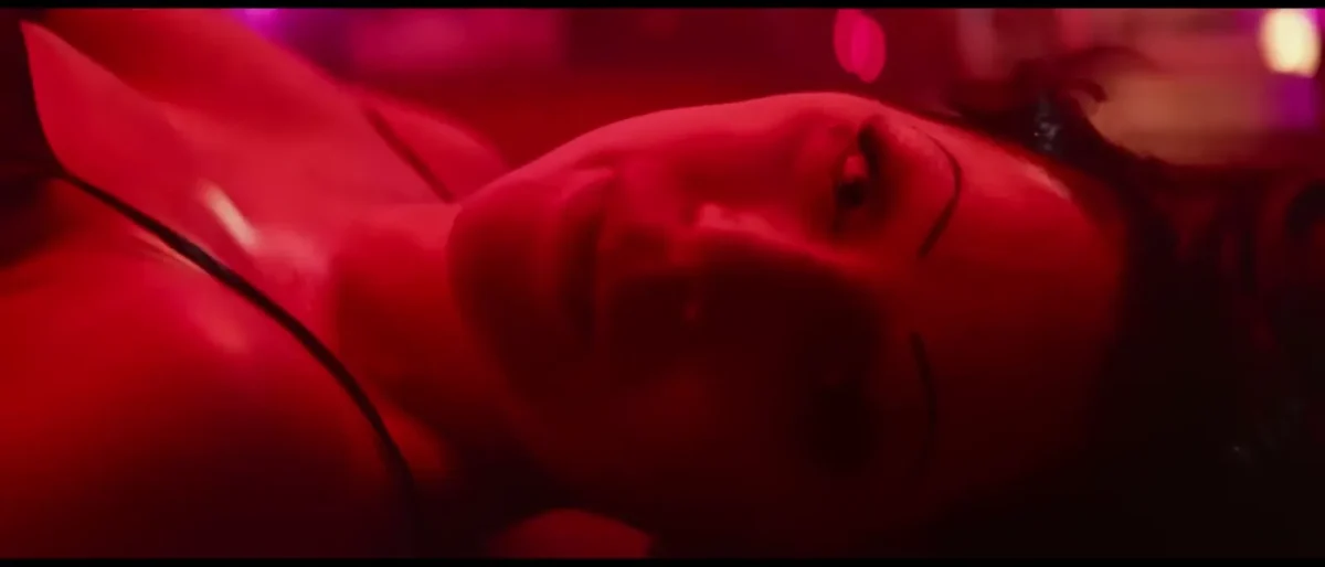 Lady Gaga as Ally lying on the bar during the La Vie en Rose scene in A Star Is Born