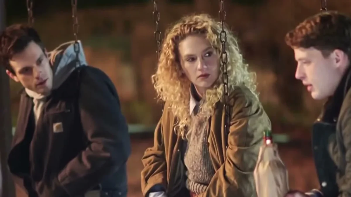 Three characters from Line of Fire talking on playground swings at night