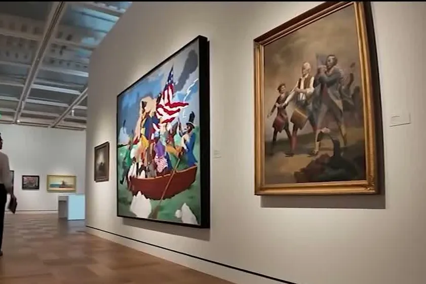 A gallery at the Lucas Museum of Narrative Art with large narrative paintings on white walls
