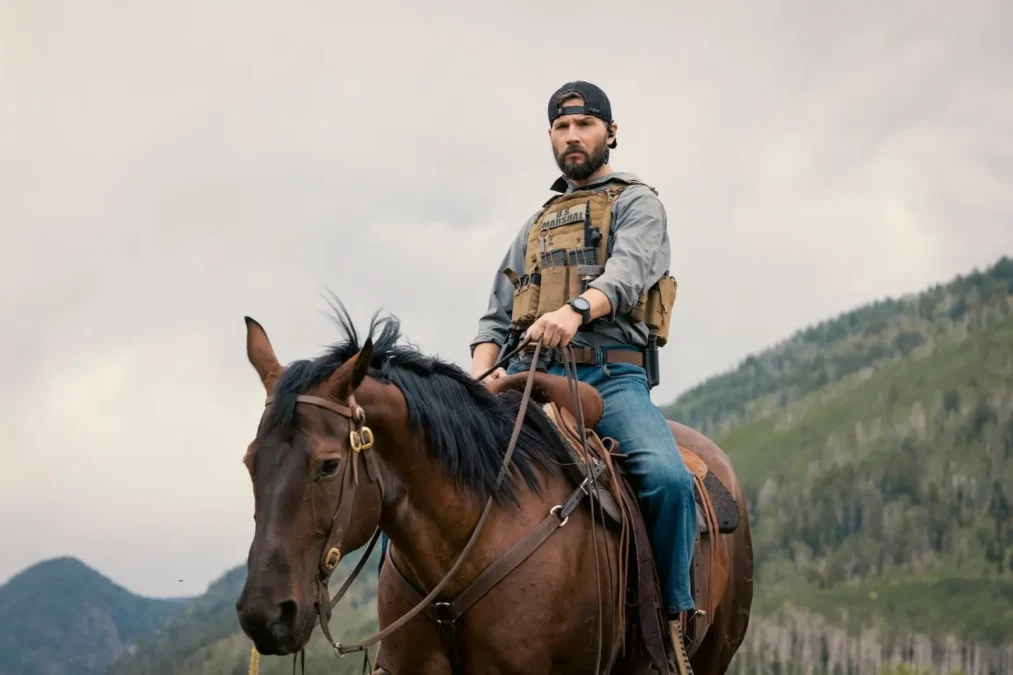 Logan Marshall-Green as Pete Calvin on horseback in a tactical vest, with mountains behind him