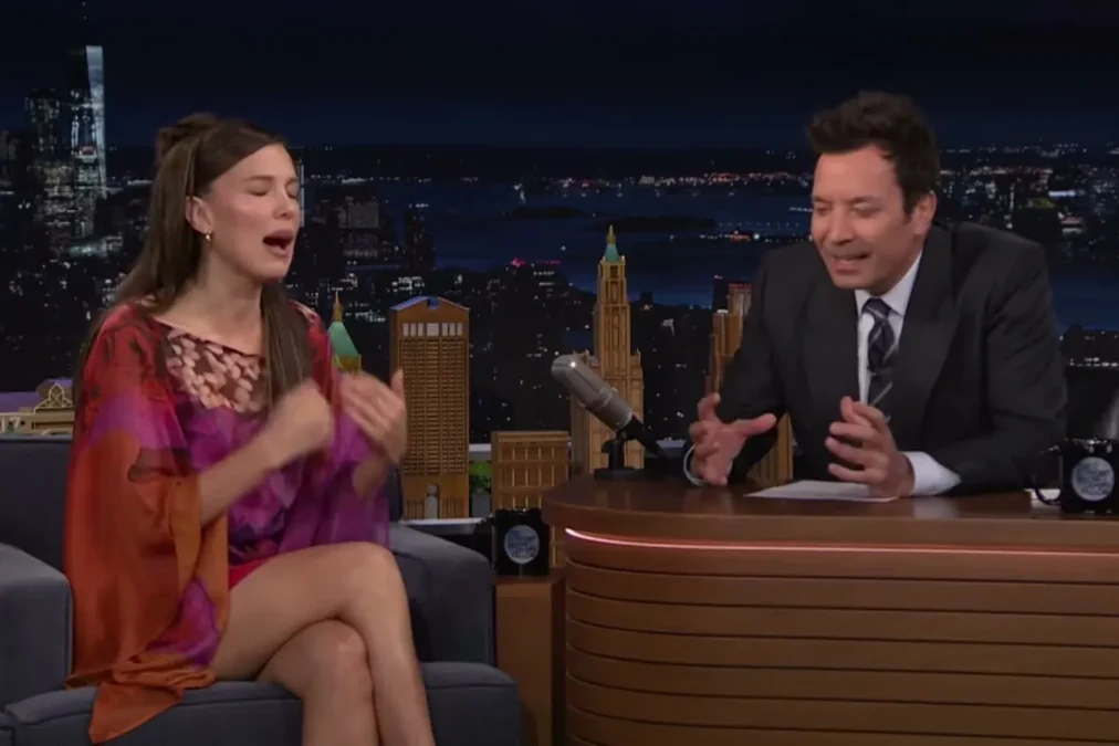 Millie Bobby Brown gesturing while talking to Jimmy Fallon on The Tonight Show