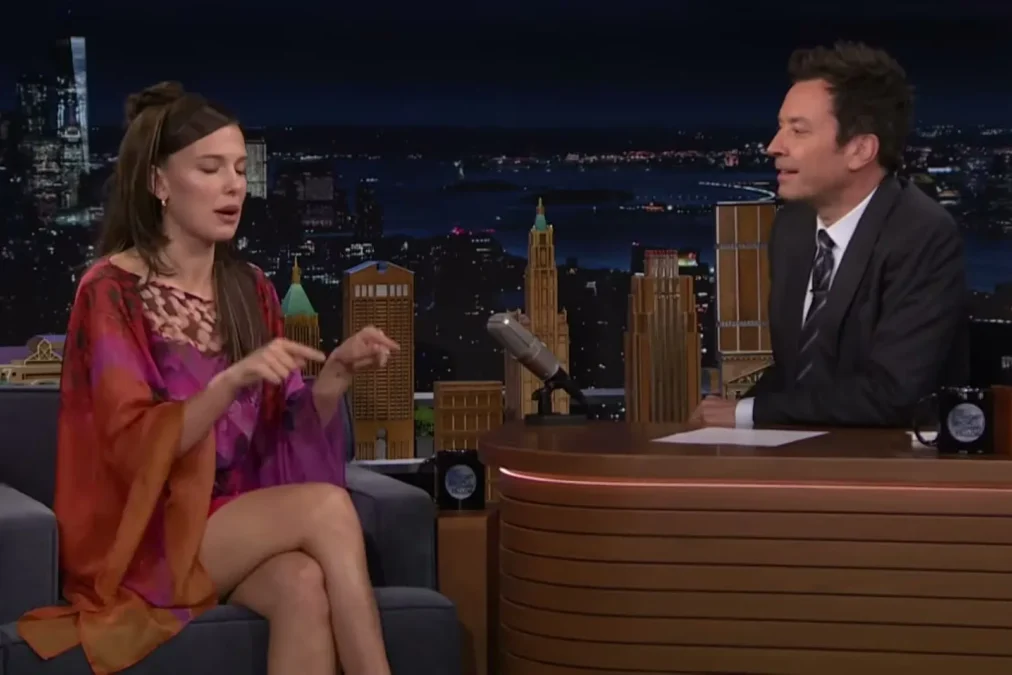 Millie Bobby Brown seated across from Jimmy Fallon at The Tonight Show desk