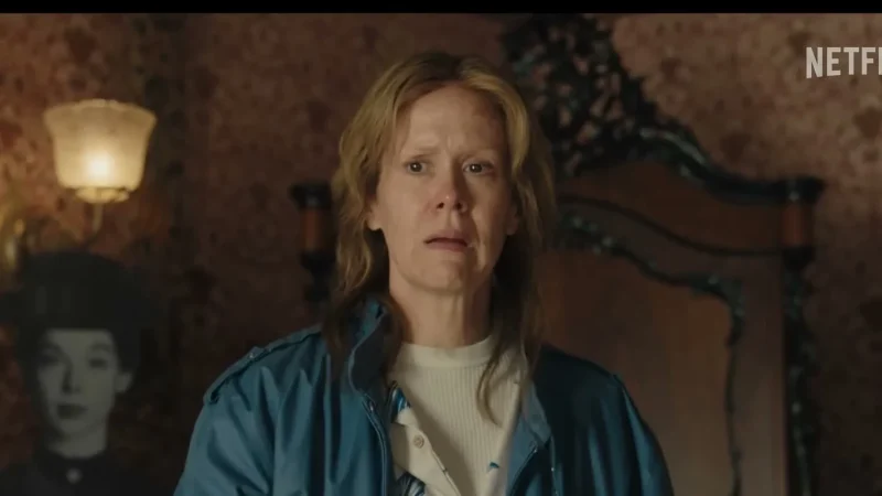 Sarah Paulson as Aileen Wuornos, in a modern blue jacket, standing in a Victorian room in Netflix's Monster
