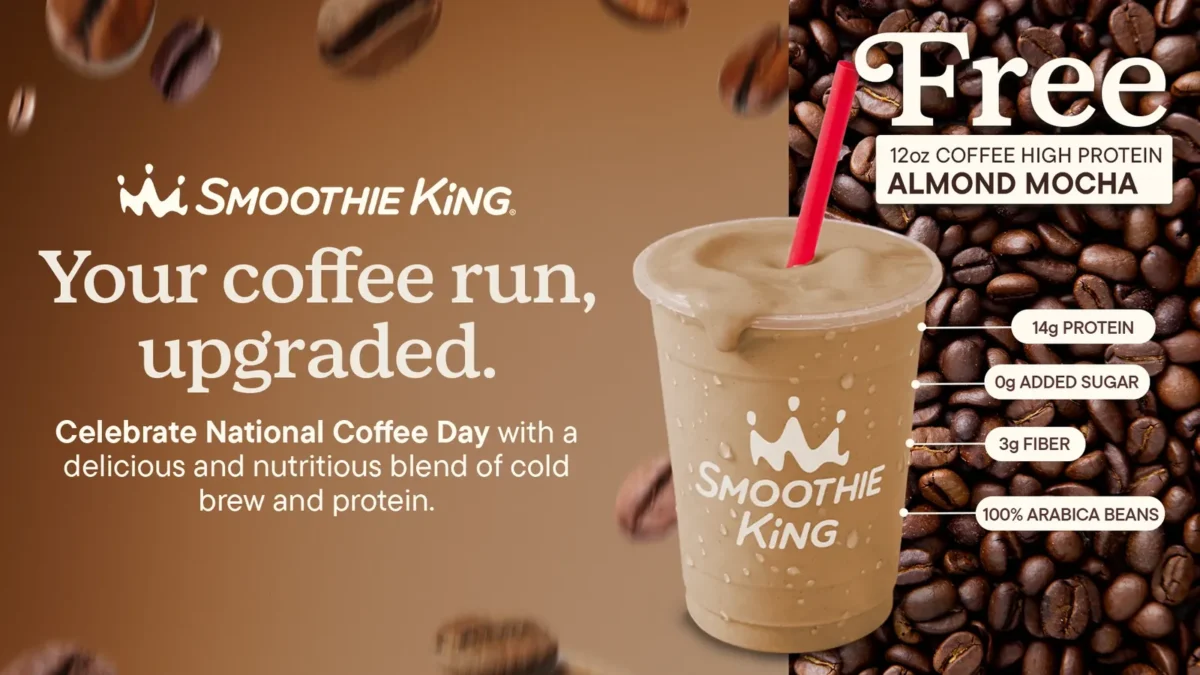 Smoothie King's Coffee High Protein Almond Mocha Smoothie in a clear cup with a red straw, next to coffee beans, in the chain's National Coffee Day promotion