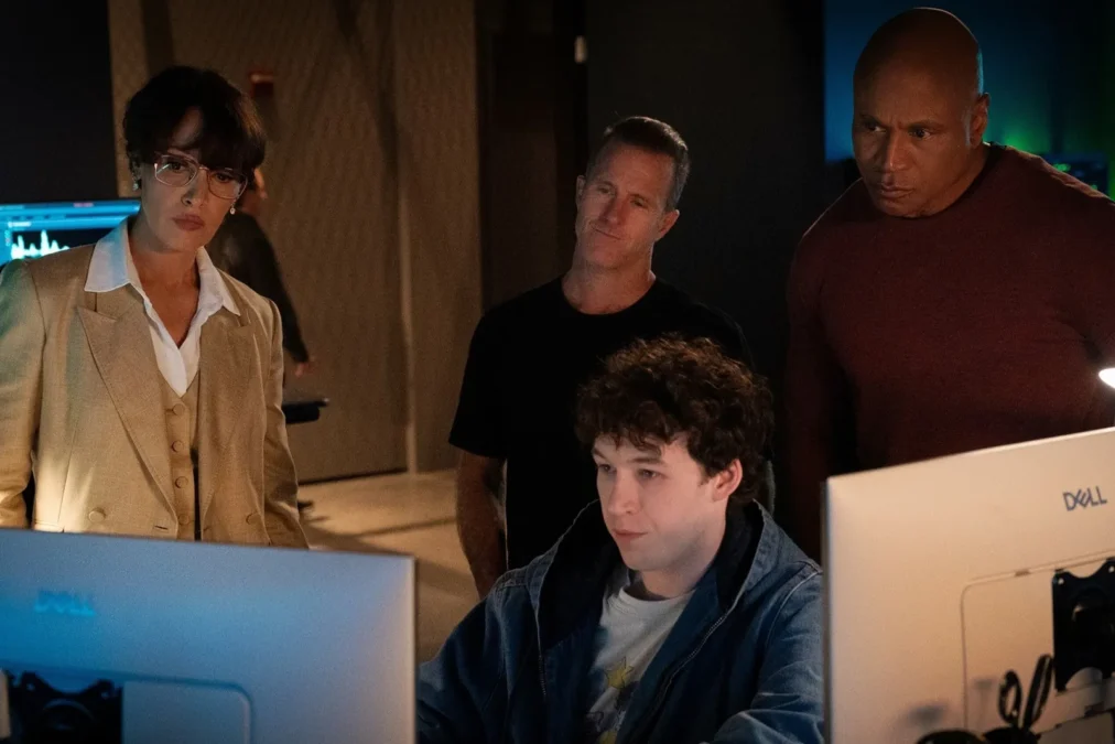 Jennifer Beals, Scott Caan and LL COOL J standing behind Devin Druid as he works at a computer in a dark office