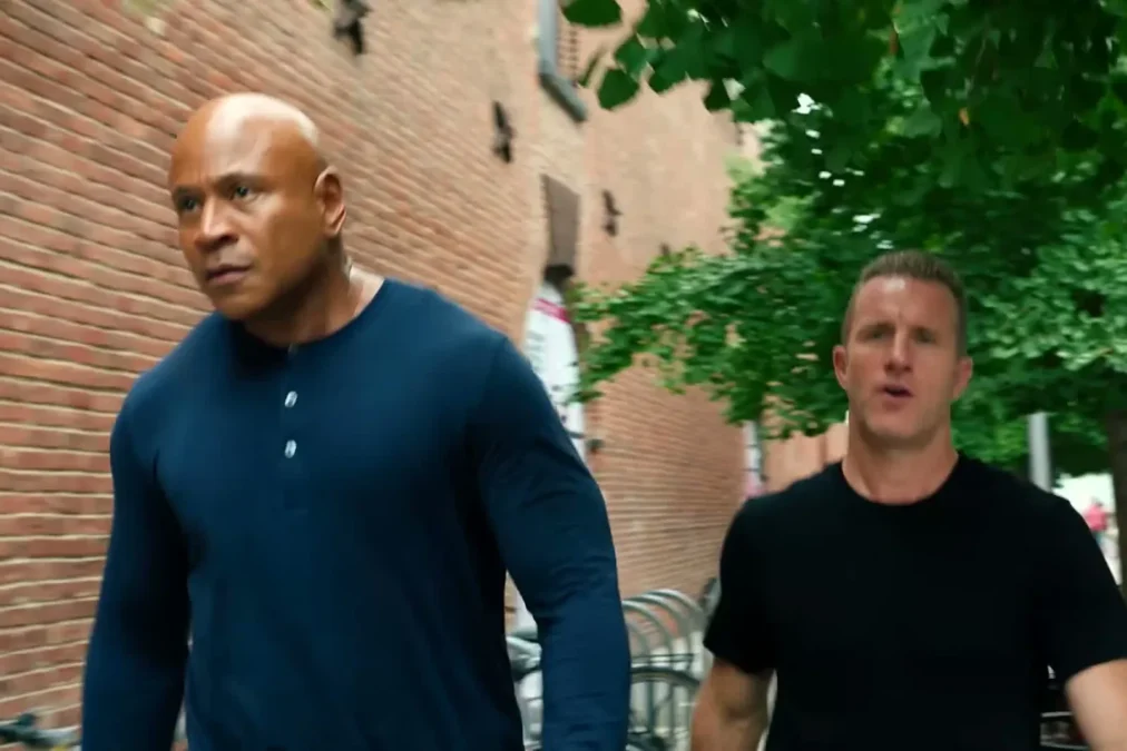 LL COOL J in a navy henley and Scott Caan in a black T-shirt walking along a brick building