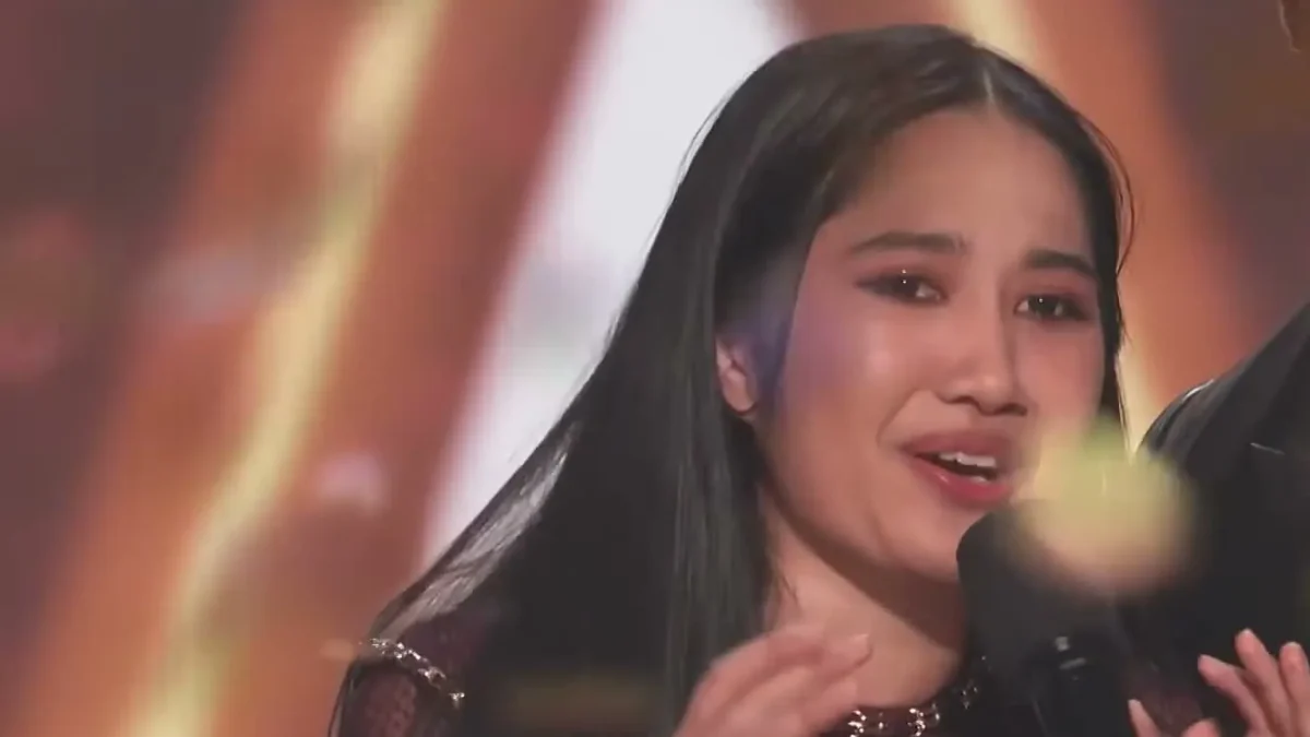 Nene Royal, emotional and speaking into a microphone as confetti falls, moments after being named the winner of America's Got Talent Season 21