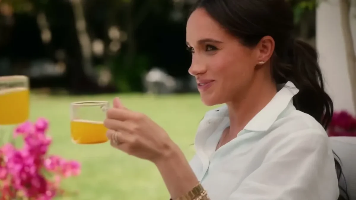 Meghan Markle smiling with a glass of juice in her Netflix series With Love, Meghan