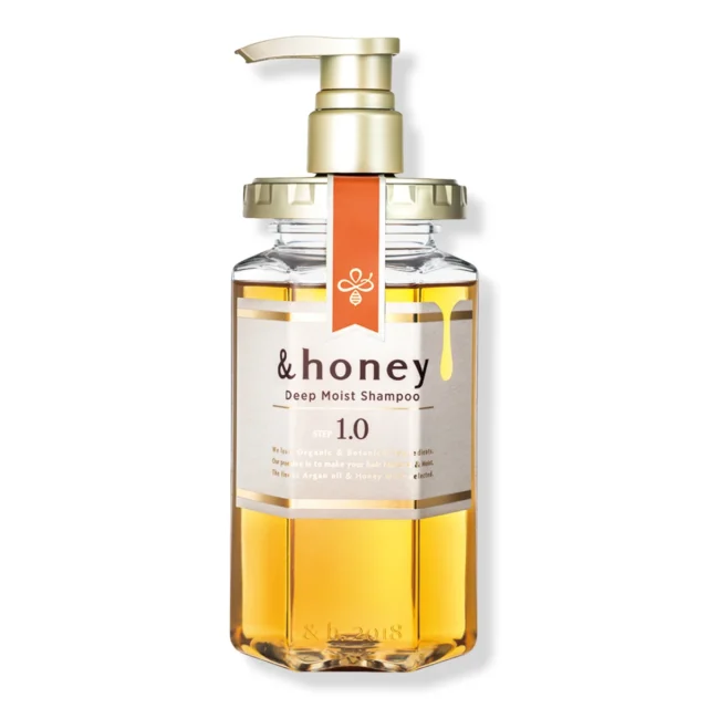 The &honey Deep Moist Shampoo, Step 1.0, in its clear hexagonal bottle with honey-colored shampoo and a gold pump