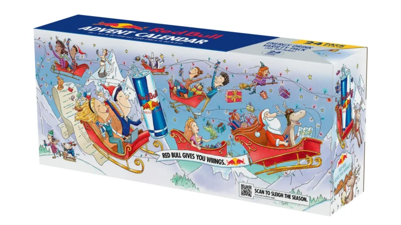 The Red Bull Advent Calendar 2026 box, a long white package illustrated with cartoon skiers, sleds and Santa's sleigh, with a QR code reading Scan to sleigh the season
