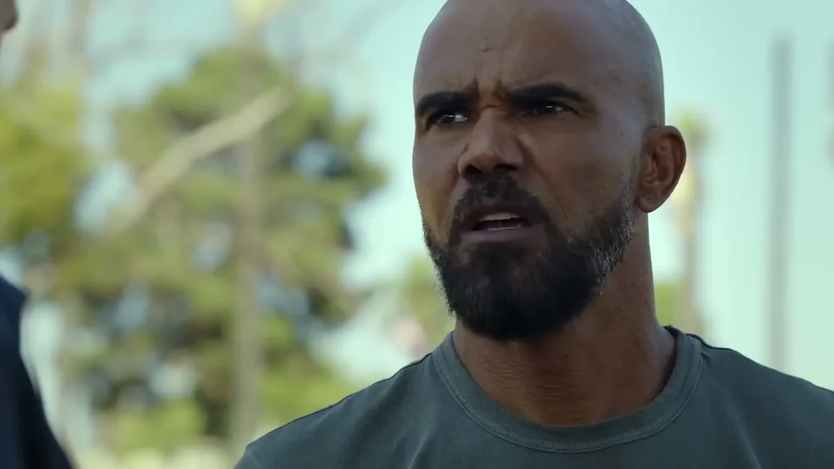 Shemar Moore as Hondo with a shaved head and beard frowning outdoors in S.W.A.T. Exiles