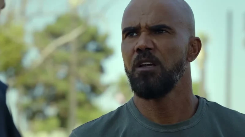Shemar Moore as Hondo with a shaved head and beard frowning outdoors in S.W.A.T. Exiles