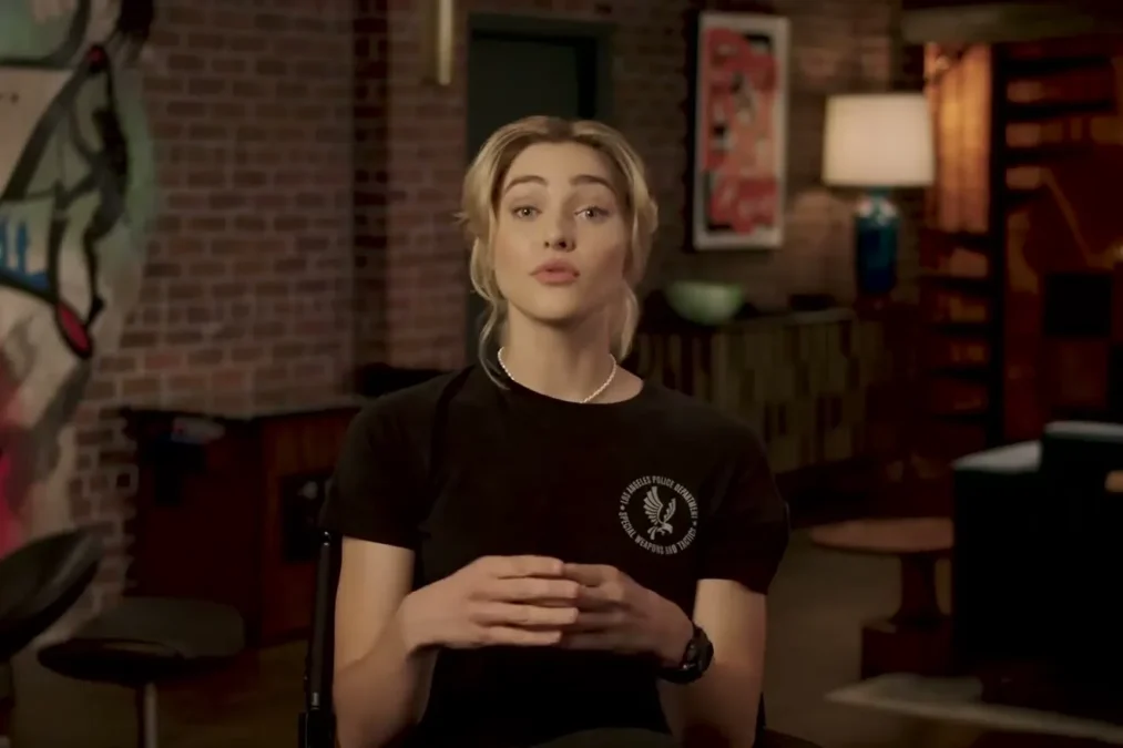 Zyra Gorecki with blond hair in a black T-shirt talking in an interview
