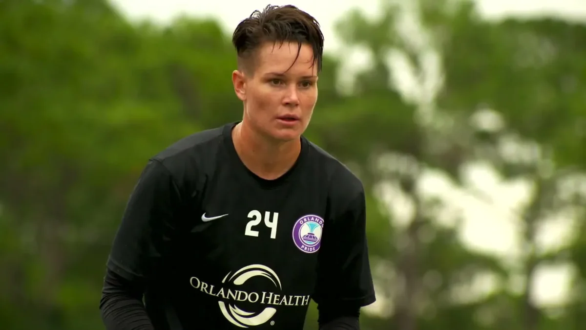 Ashlyn Harris in a black Orlando Pride goalkeeper jersey with the number 24 on a practice field