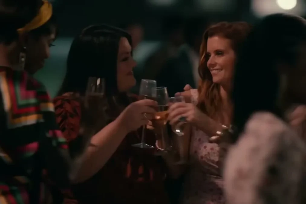 JoAnna Garcia Swisher raising a glass with her Sweet Magnolias castmates at a night party