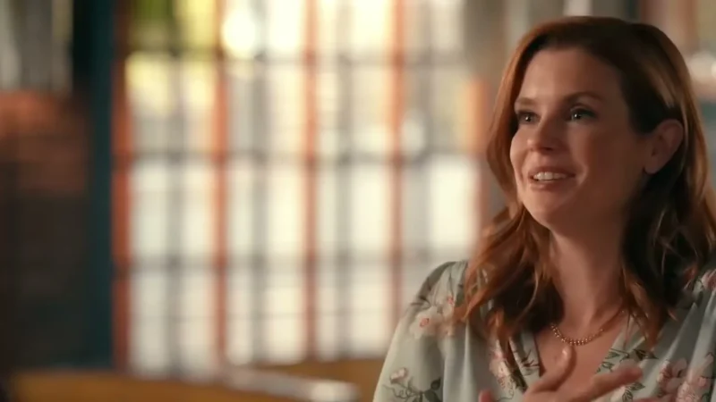 JoAnna Garcia Swisher as Maddie Townsend smiling with a hand on her chest in Sweet Magnolias