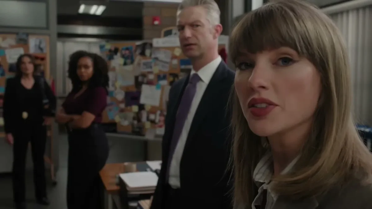 Taylor Swift in a detective's suit looks into the camera during the Law and Order: SVU sketch at the 2026 Emmys