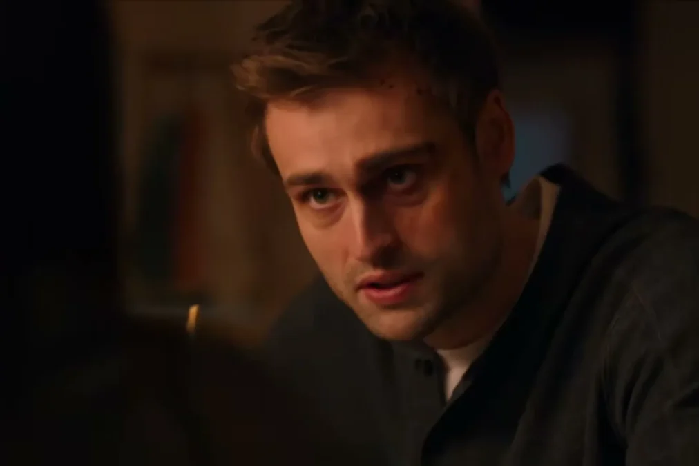 Douglas Booth as DI Tom Radley leaning in during a dimly lit scene in The Blame