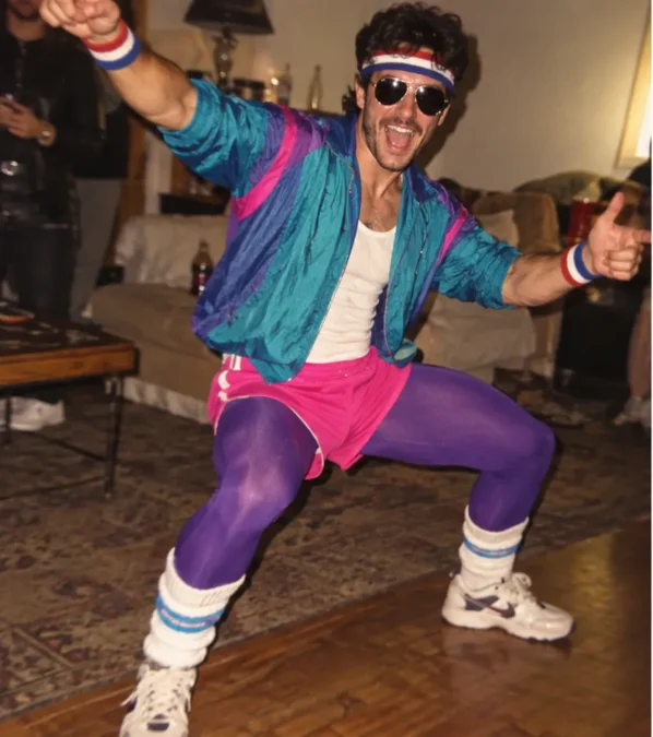 Illustration of a man dressed as an '80s aerobics instructor in a teal and purple windbreaker, pink shorts over purple tights, sweatbands and tube socks