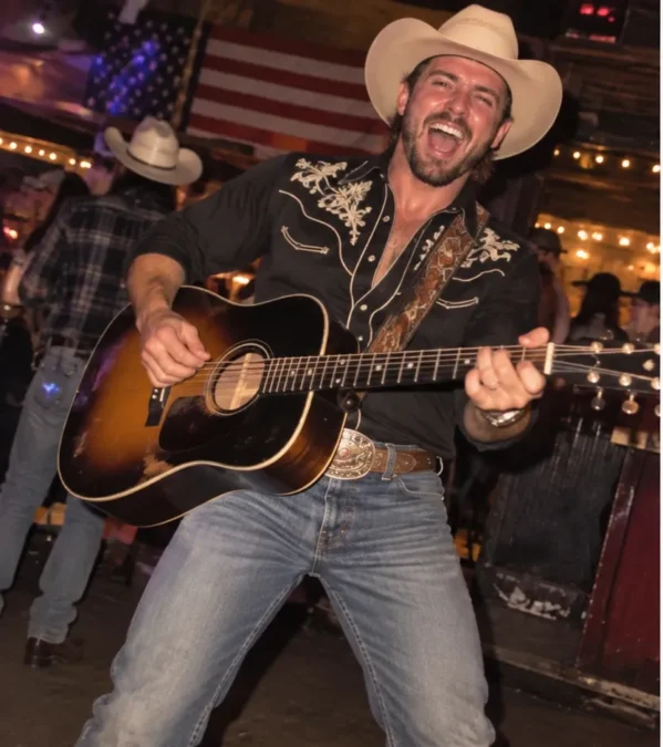 Illustration of a man dressed as a country singer in a cowboy hat, embroidered black Western shirt, big belt buckle and jeans, playing an acoustic guitar in a honky-tonk