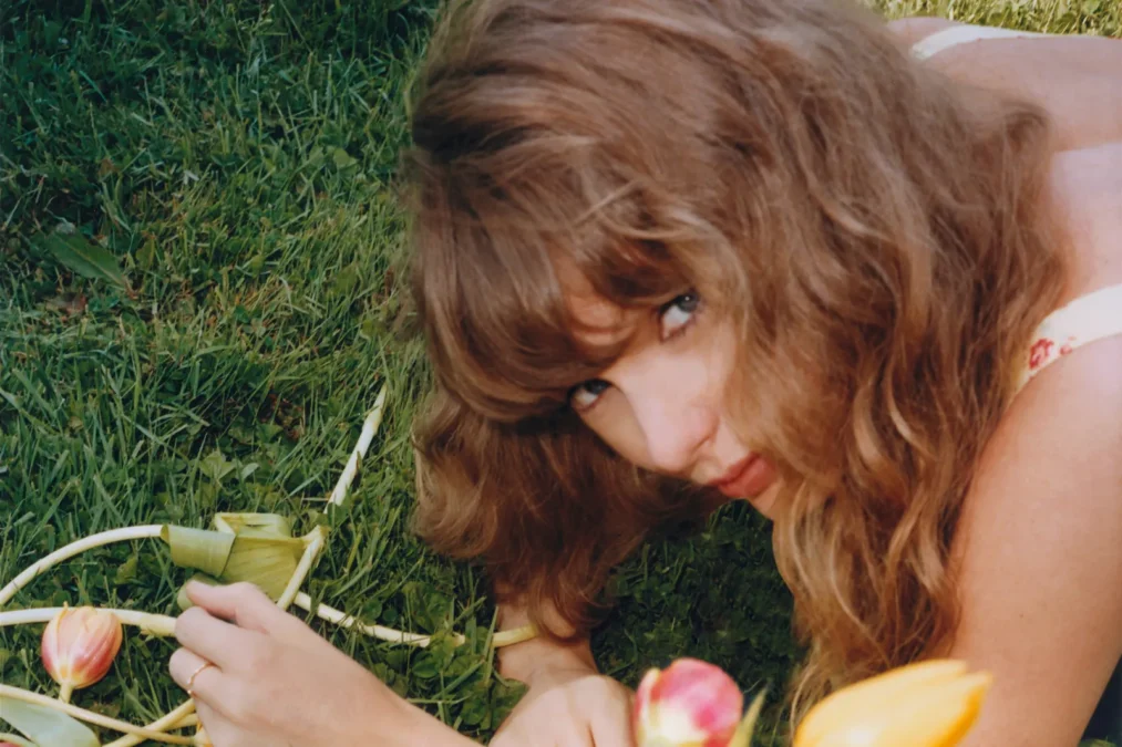 Taylor Swift lying on the grass among tulips in a photo she shared on Instagram