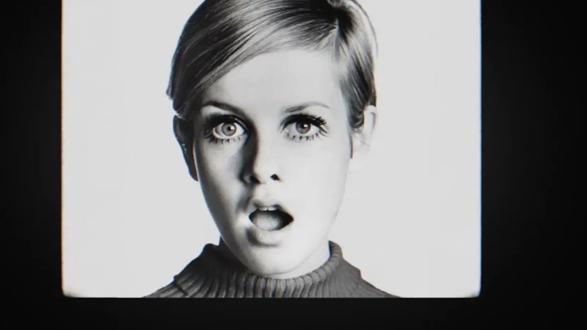 Black and white archival portrait of Twiggy in the 1960s, with her cropped hair and painted lower lashes