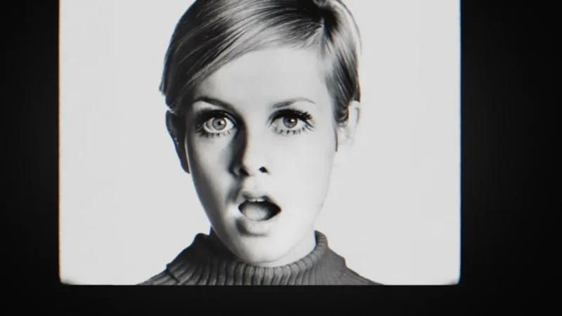 Black and white archival portrait of Twiggy in the 1960s, with her cropped hair and painted lower lashes