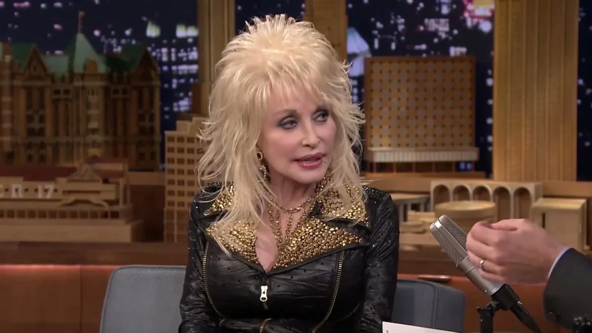 Dolly Parton in a voluminous platinum blonde wig and a studded black leather jacket on The Tonight Show