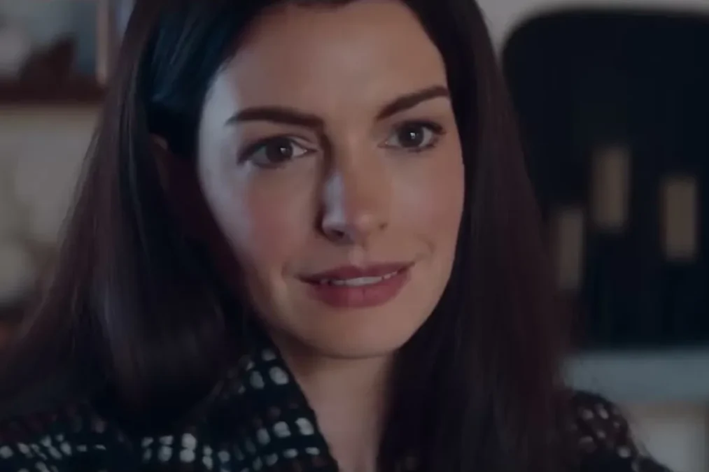 Anne Hathaway smiling in a kitchen in a scene from the Verity teaser