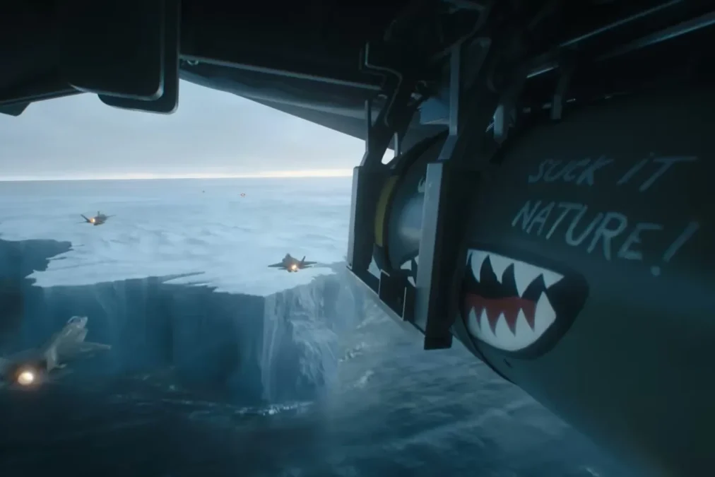 A bomb painted with a shark mouth and the words Suck It Nature hangs under a plane over a collapsing ice shelf