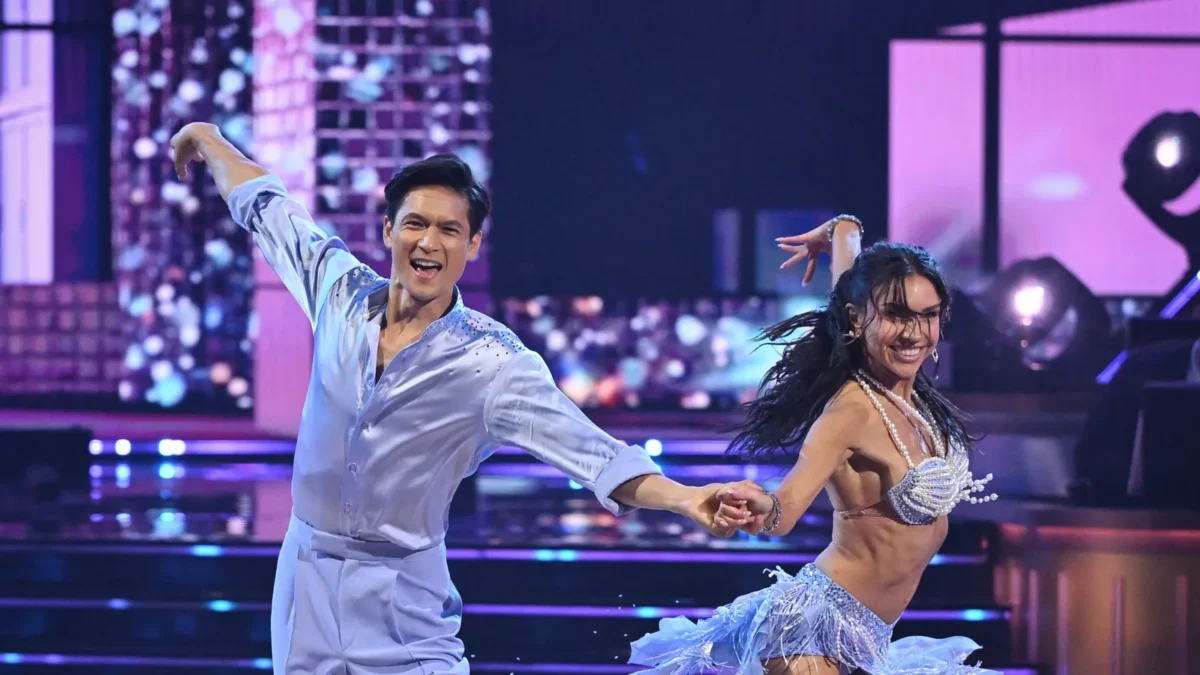 Harry Shum Jr. smiles during a cha-cha with pro partner Jenna Johnson on Dancing With the Stars season 35