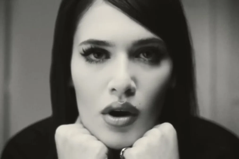 Black-and-white close-up of Sienna Spiro resting her chin on her fists in the Die On This Hill music video
