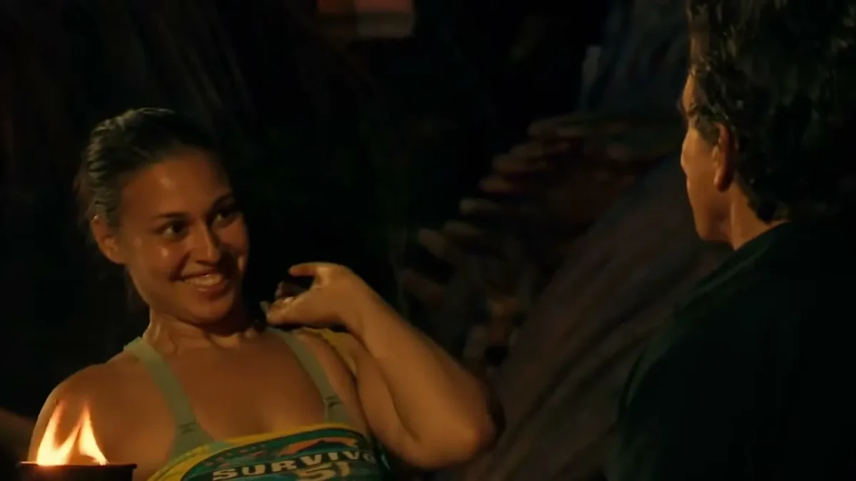 Aaliyah Puglia smiles as she holds her torch beside host Jeff Probst at the first Tribal Council of Survivor 51