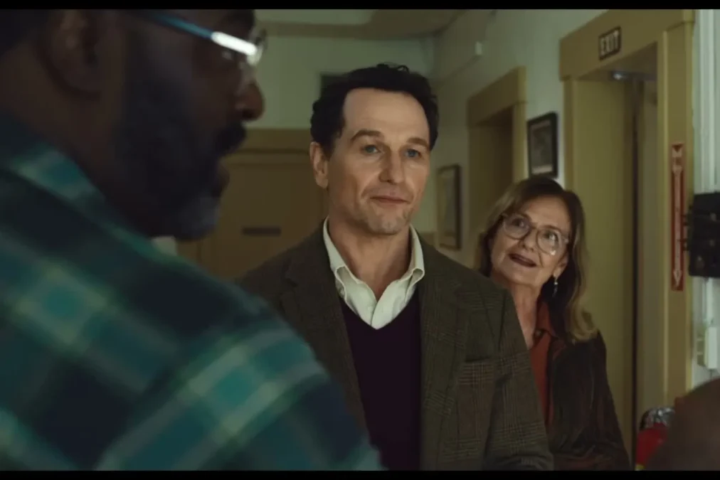 Matthew Rhys as Mayor Tom Loftis talking to two residents inside the Widow's Bay town hall